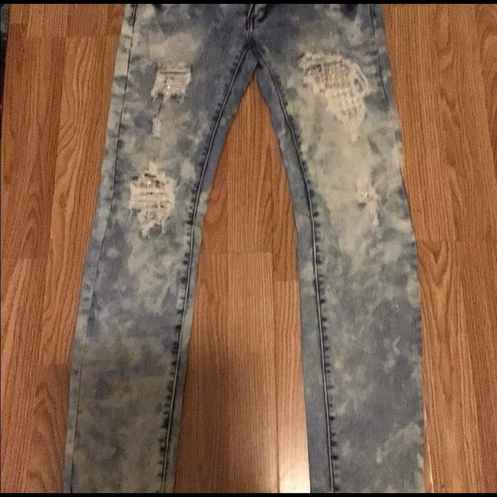 Machine acid washed distressed jeans with jewel embellishments